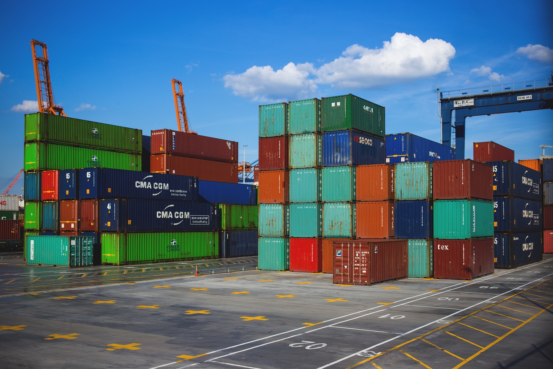 shipping containers stacked in a port ready to be moved