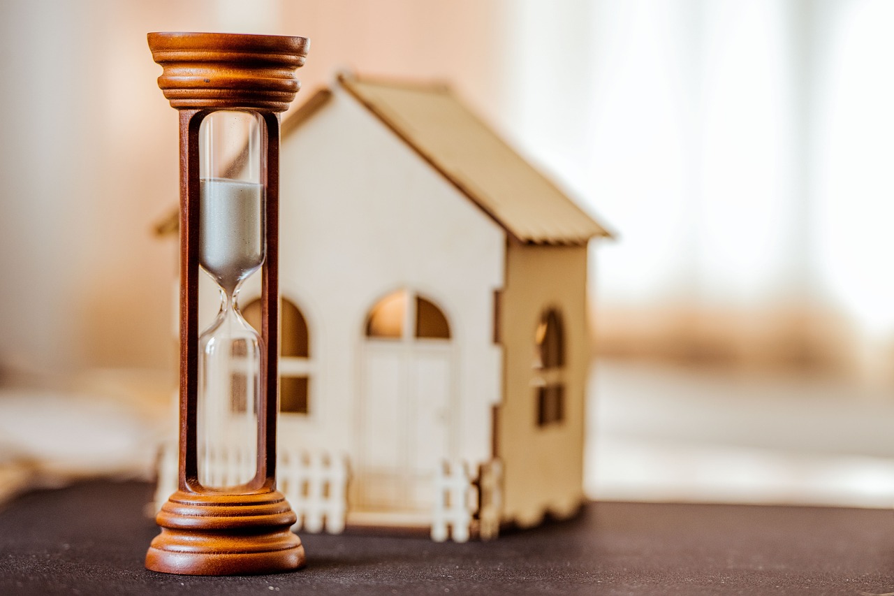 model house with an hourglass on a table