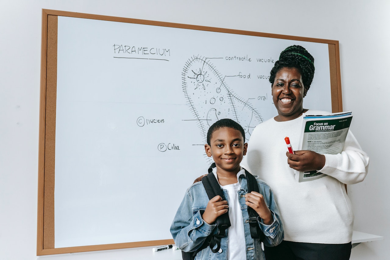 people in front of a white board with a cell diagram on it 