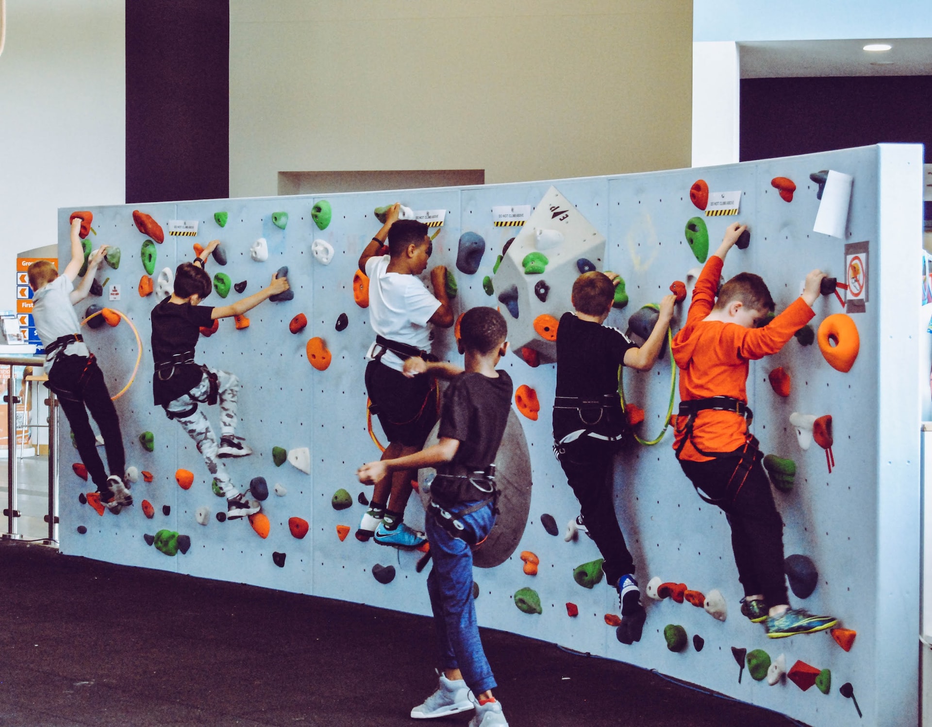 students on a climbing wall in a classroom
