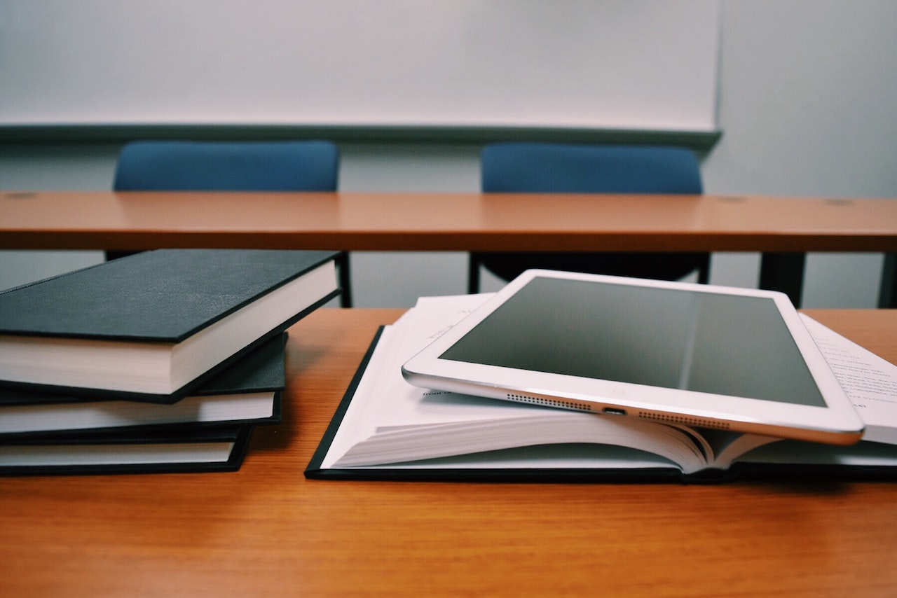 textbook with tablet in school