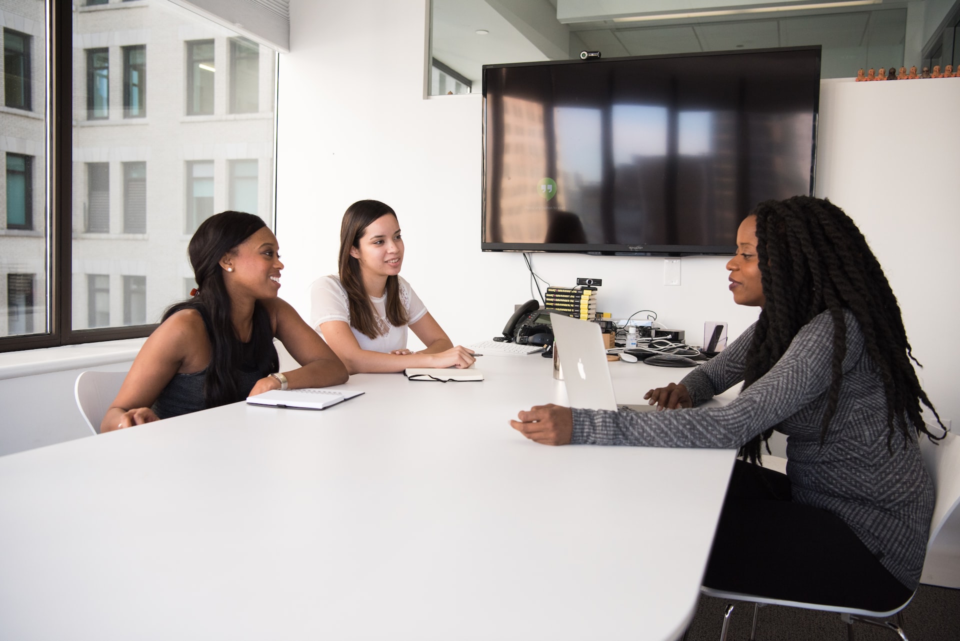 people in an office room having a meeting