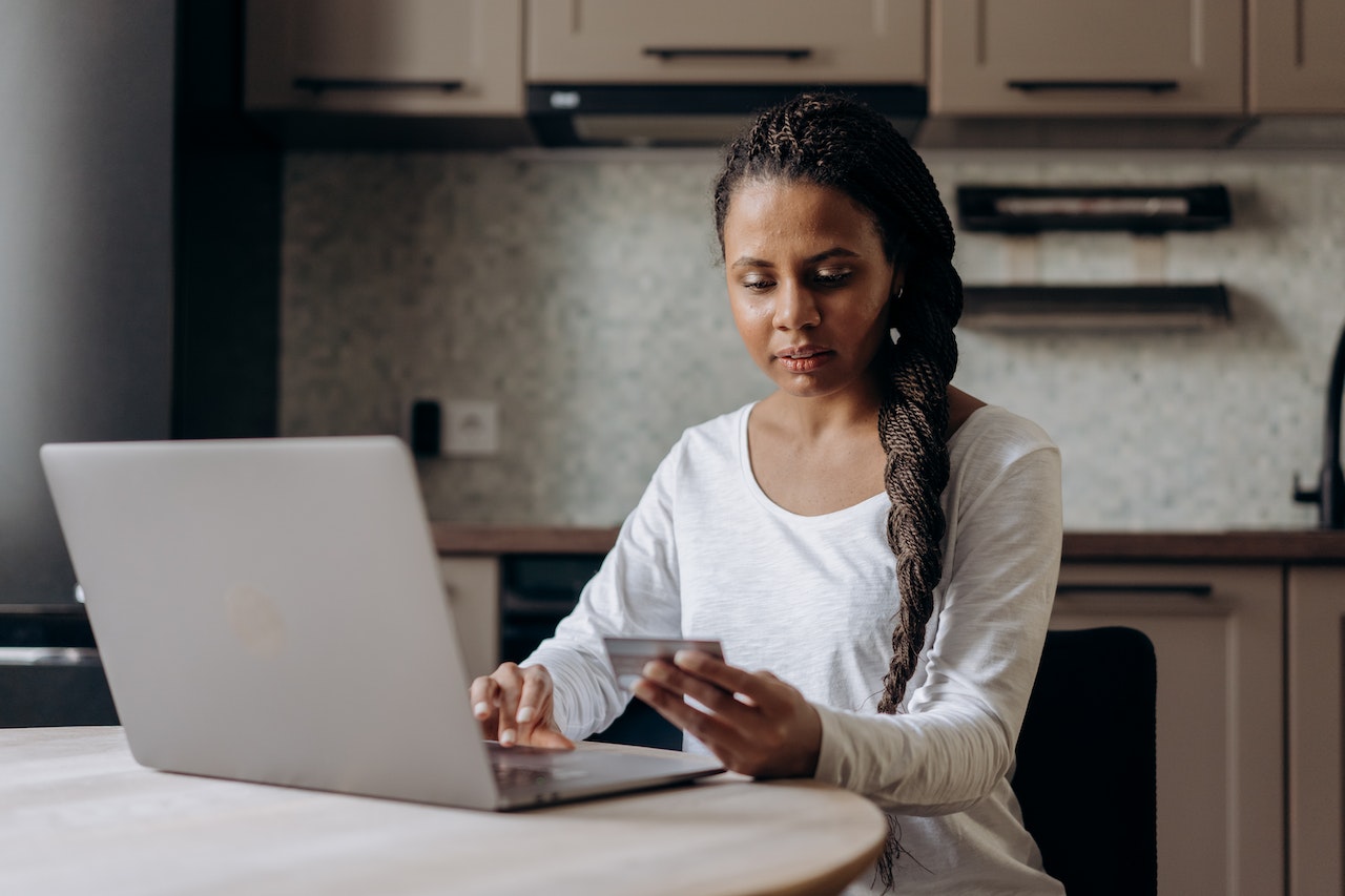 person using a credit card on their laptop