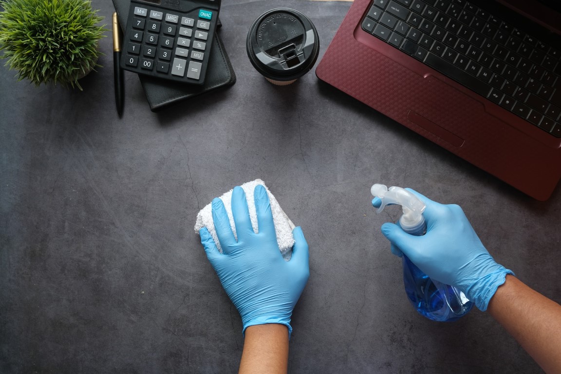 Disinfecting a surface with a spray bottle and cloth