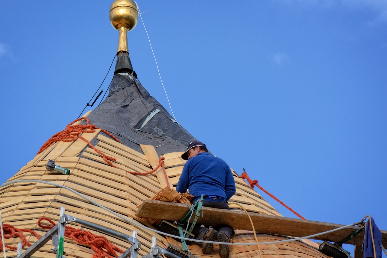 a person fixing an older roof 