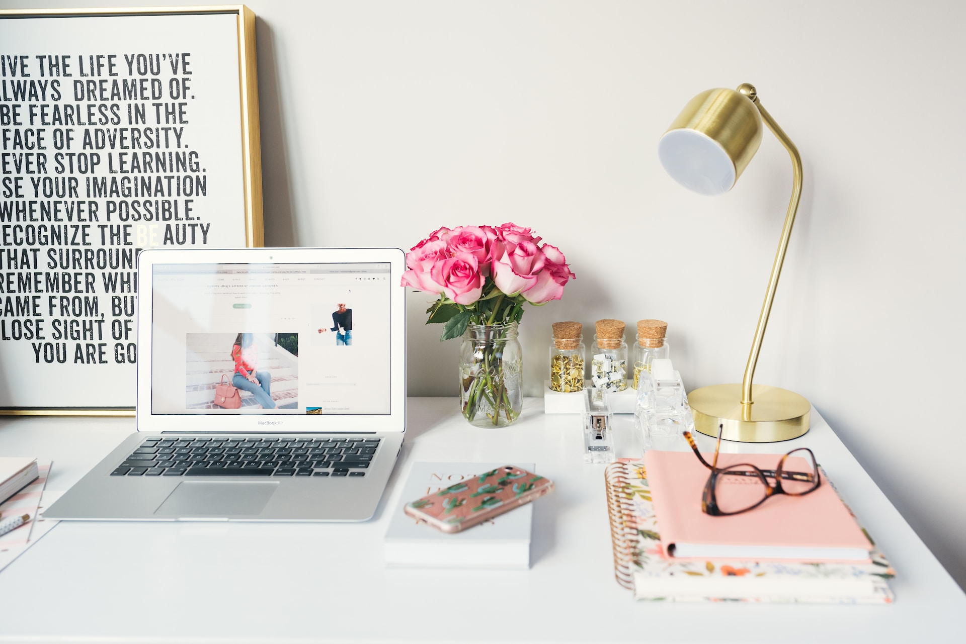 laptop on desk beside a lamp