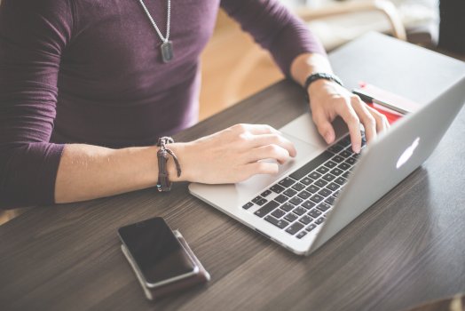 man typing on laptop, background check, been verified 