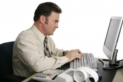 man accounting software oneup computer typing doing taxes monitor