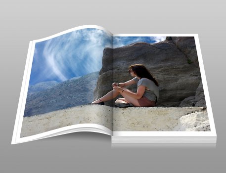 photo book with picture of girl sitting on a beach near a rock, picaboo
