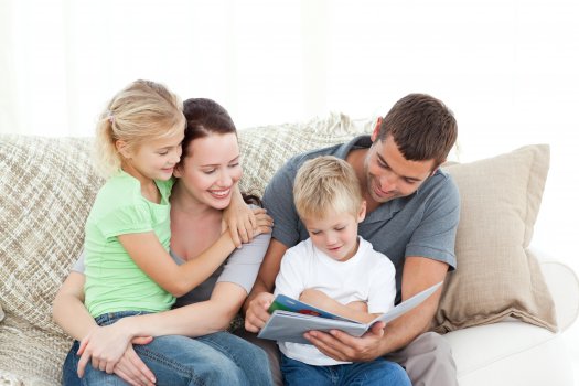 happy family with kids looking at photo book, shutterfly