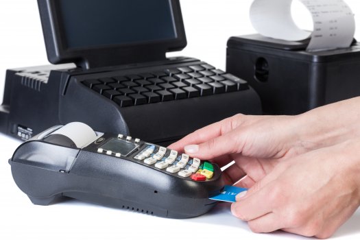 hand inserting a credit card in credit card reader and black cash register, pos, square register