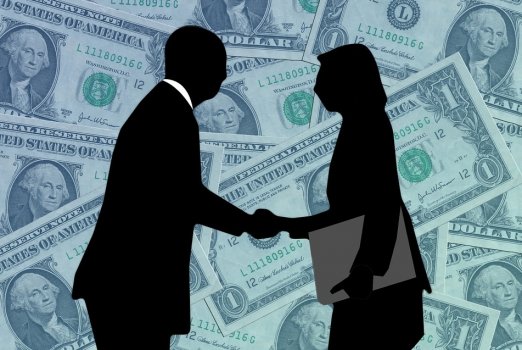 man and woman in business attire shaking hands on background with dollars, payday loans, lending club